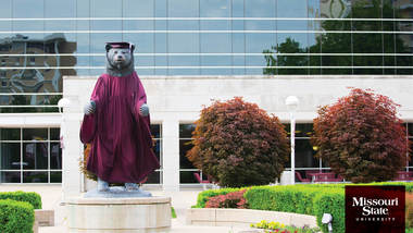 Zoom background: Bear statue ready for commencement.